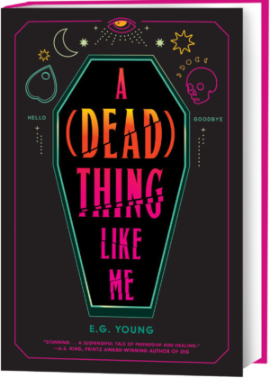 Cover for A (Dead) Thing Like Me, showing an illustrated coffin with the title inside. Illustrated Ouija board elements (a planchette, a skull, an all-seeing eye, stars, and moon phases, and the words “hello” and “goodbye”) surround the coffin. The background color is black, and the coffin and elements are hot pink, turquoise, yellow, and orange. In hot pink, a blurb from AS King, Printz award-winning author of “Dig,” says, “Stunning … a suspenseful tale of friendship and healing”