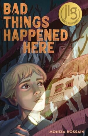 Cover for Bad Things Happened Here, showing a biracial boy with light hair holding a flashlight, which is pointing at an abandoned building. There’s a woman with glowing eyes standing in one of the windows. In the background there’s a south Asian girl’s face partially covered by banana leaves. She looks worried. The book title is in a creepy font in orange.