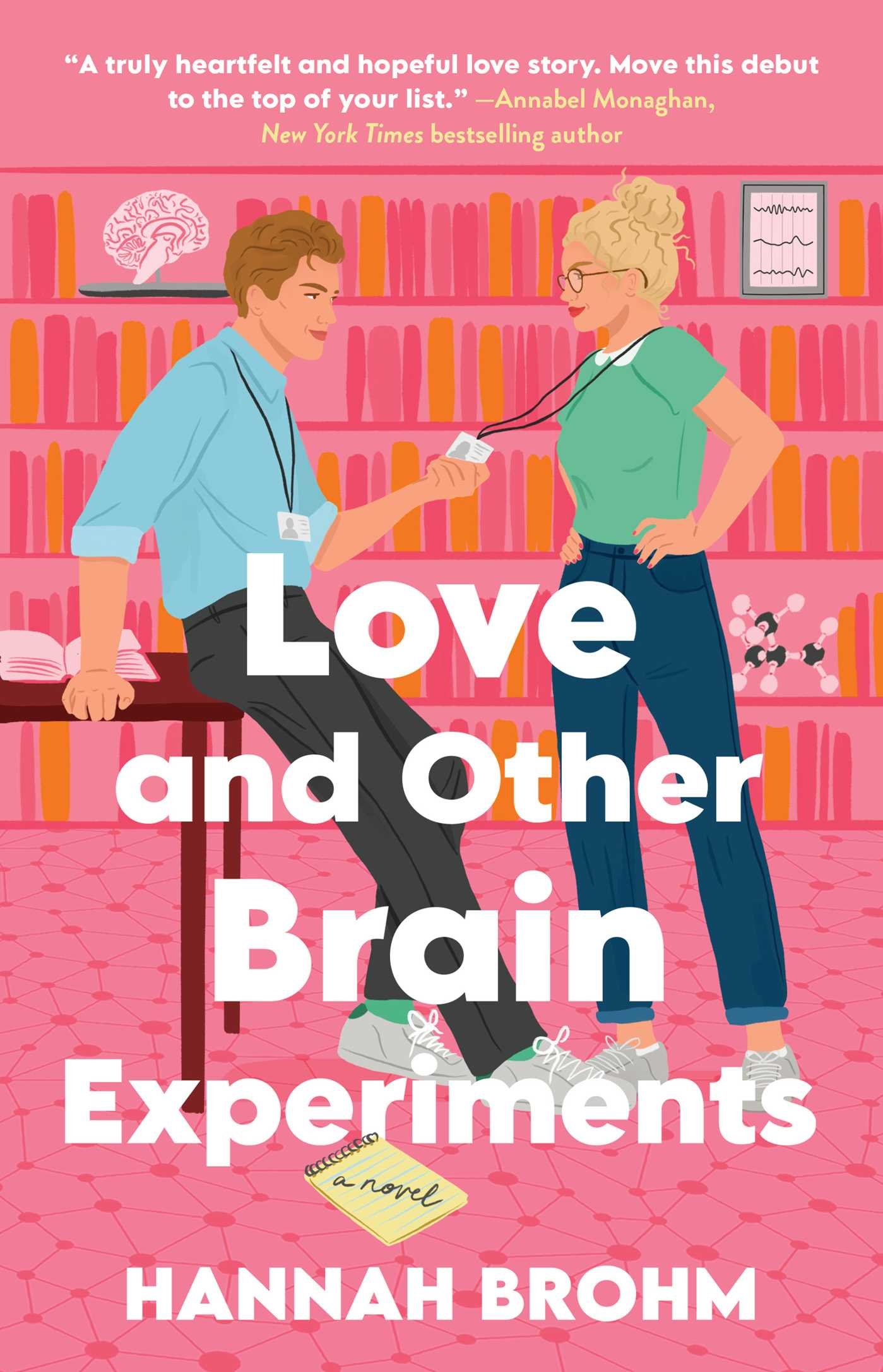 Cover for Love and Other Brain Experiments, showing two illustrated people in front of a pink background. One is a white man leaning against a table wearing a blue shirt, and with his hands around the lanyard of the woman opposite him, who wears a green shirt and has her hands propped against her waist. Bookshelves are in the background carrying book and varying science items, like a diagram, a 3D model of a brain and an atom model.