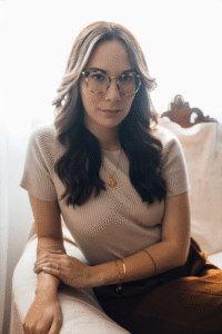 Headshot of Rachel Kitch, author, wearing professional clothes and smiling softly.