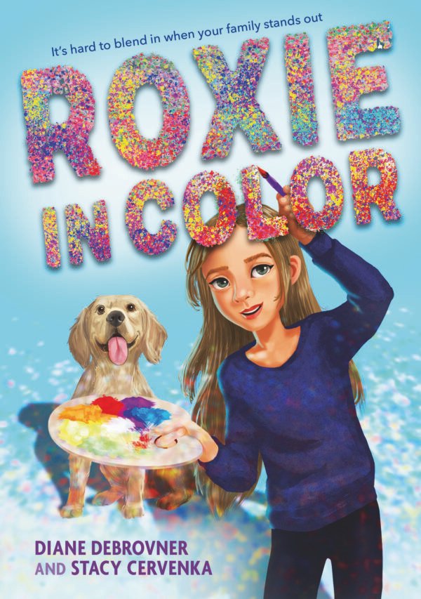 Colorful dots make up title and a girl with long brown hair is painting the letter O. She is holding an easel. Behind her is a yellow Labrador with his tongue hanging out.