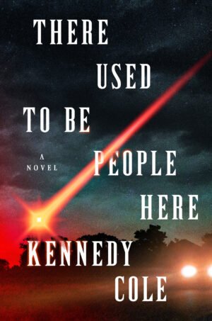 Cover for There Used to Be People Here, showing a starry night sky with a red streaked comet across it. A car with bright headlights sits on the road beneath the title. The book title and the author’s name are written in a bold, large cap font.